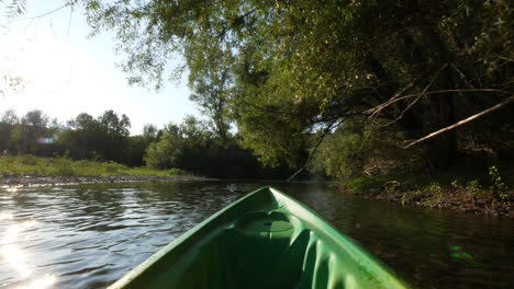 Canoeing-underneath-some-trees-Herault-river-first-point-of-view-France-summer